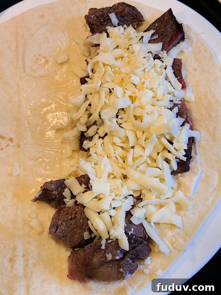 Leftover Smoked Prime Rib on flour tortilla with horseradish sauce and shredded cheese