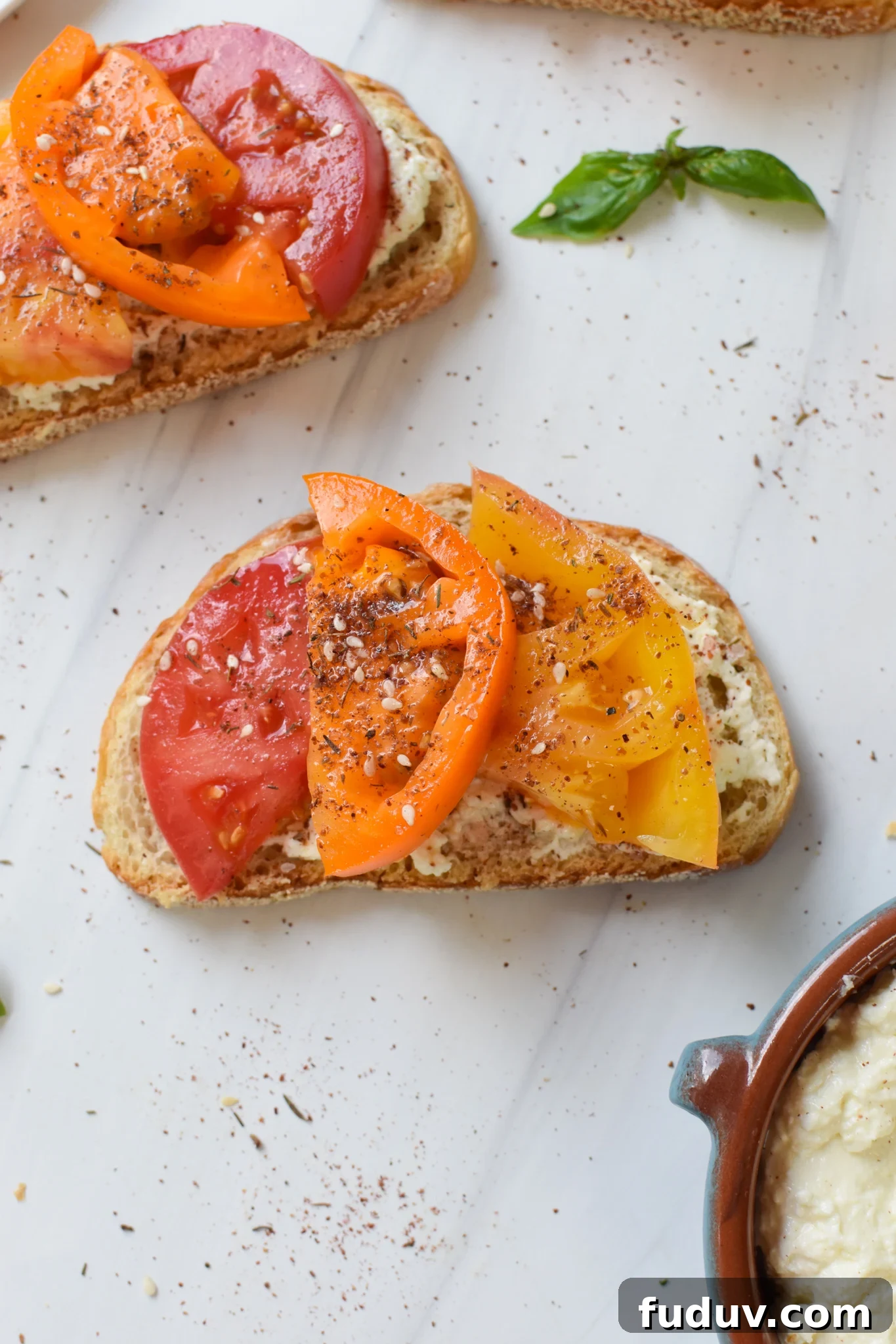 Tomato Toast with Whipped Feta with fresh basil.