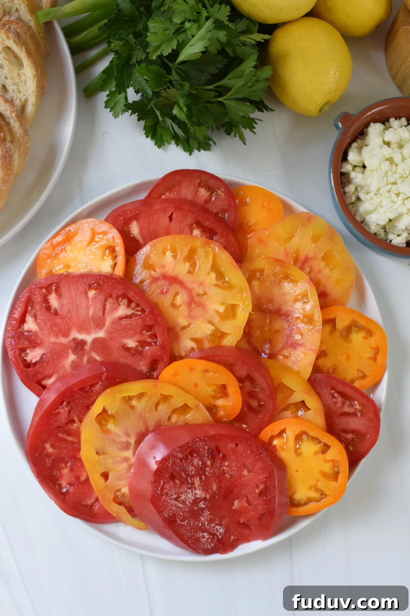 Tomato Toast with Whipped Feta heirloom tomatoes on a white plate.
