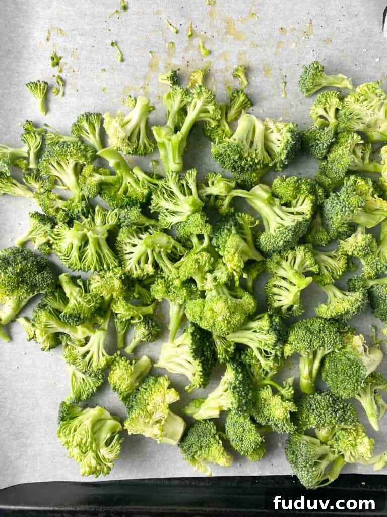 Chopped broccoli florets on a sheet pan.