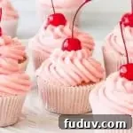 cherry cupcakes on a cake stand