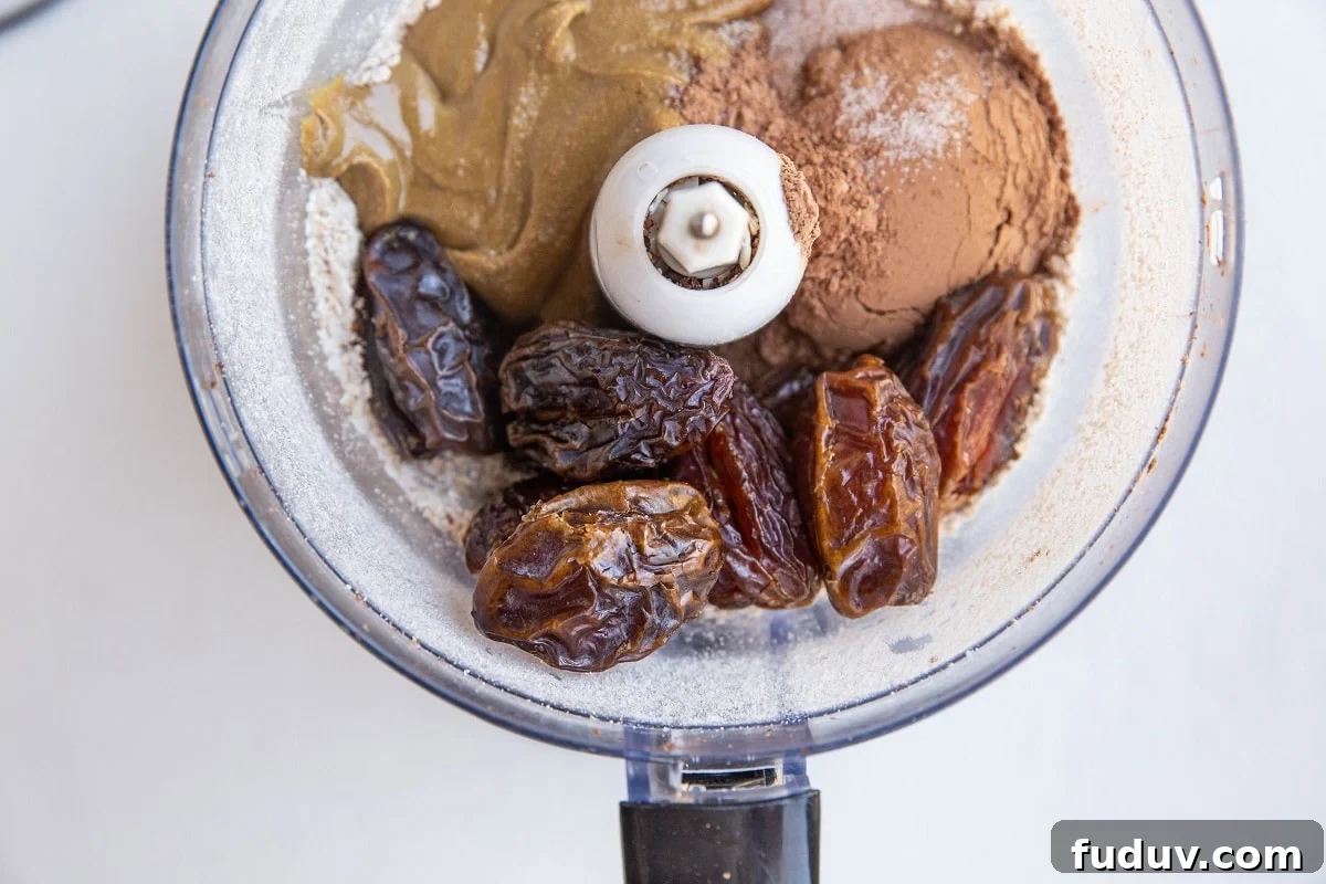 5-Ingredient Chocolate Date Energy Bites for Quick Fuel 8 all of the ingredients for the energy bites in a food processor