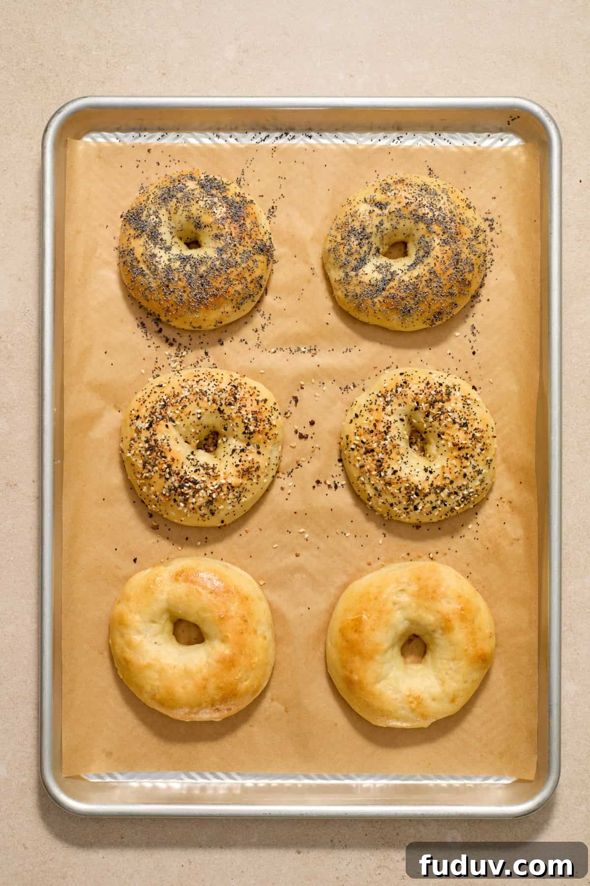 Baked protein bagels on parchment lined cookie sheet.