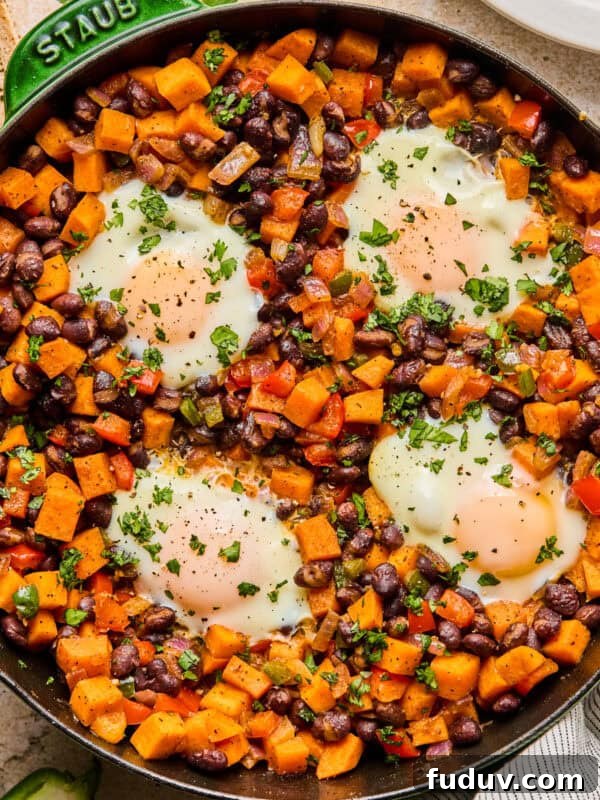 Sweet potato breakfast hash with black beans in skillet.