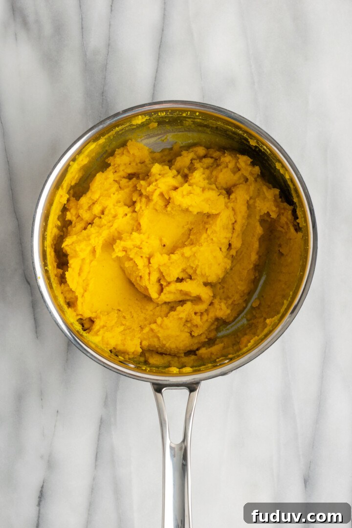 Overhead view of mashed lentils in saucepan