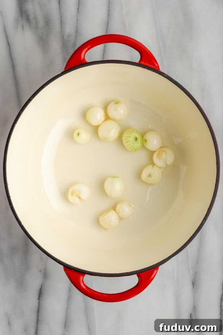 Overhead view of pearl onions in Dutch oven