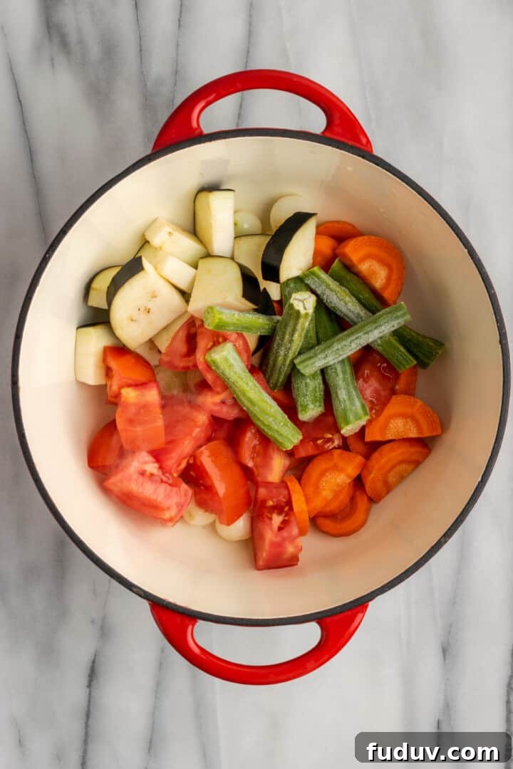 Overhead view of uncooked vegetables in Dutch oven