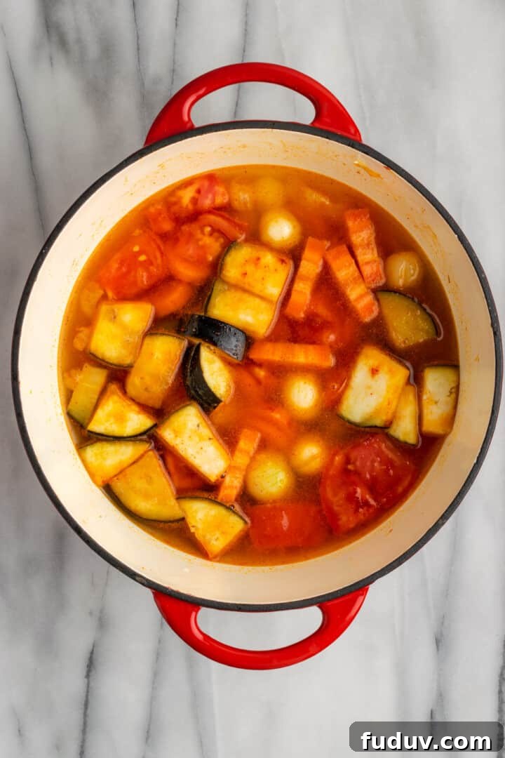 Overhead view of vegetables in Dutch oven with water