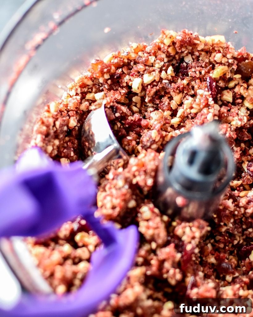 Spiced Berry Energy Balls: No-Bake Snack Recipe 4 date nut mixture in a food processor bowl for the spiced berry bliss balls.