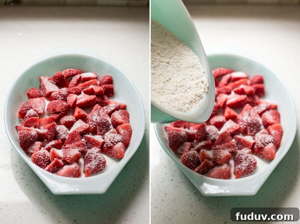 Strawberries in a baking dish and flour mixture being poured over the top