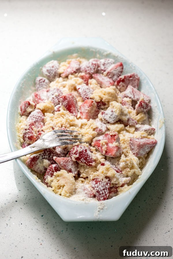 Mixing up the ingredients with a fork for strawberry dump cake batter