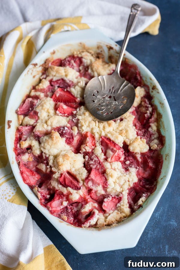 Baked strawberry dump cake in an oval baking dish
