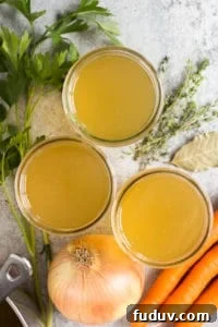 30+ Delicious Recipes to Transform Leftover Turkey 3 top down shot of mason jars filled with turkey stock and ingredients lying next to them