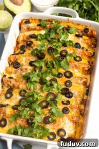 30+ Delicious Recipes to Transform Leftover Turkey 6 A large white casserole dish with turkey enchiladas in it, topped with sliced olives and cilantro.