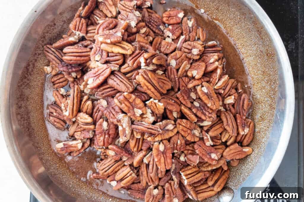 Quick Candied Pecans Recipe: Sweet Glazed Pecans in 20 Minutes 7 coating pecans in syrup mixture in pan