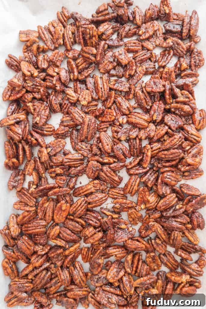 Quick Candied Pecans Recipe: Sweet Glazed Pecans in 20 Minutes 10 Candied pecans cooling on parchment lined tray