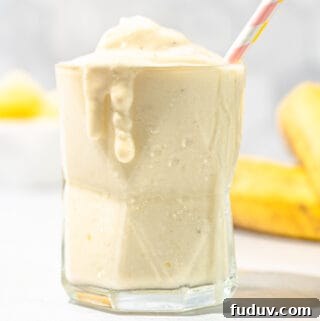 pineapple banana smoothie with bananas in background