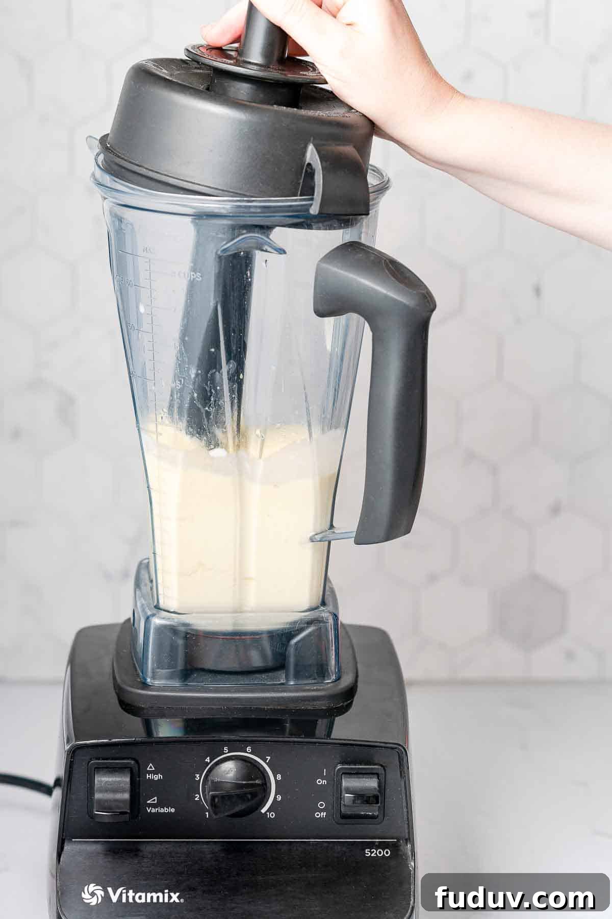 smoothie being blended with tamper
