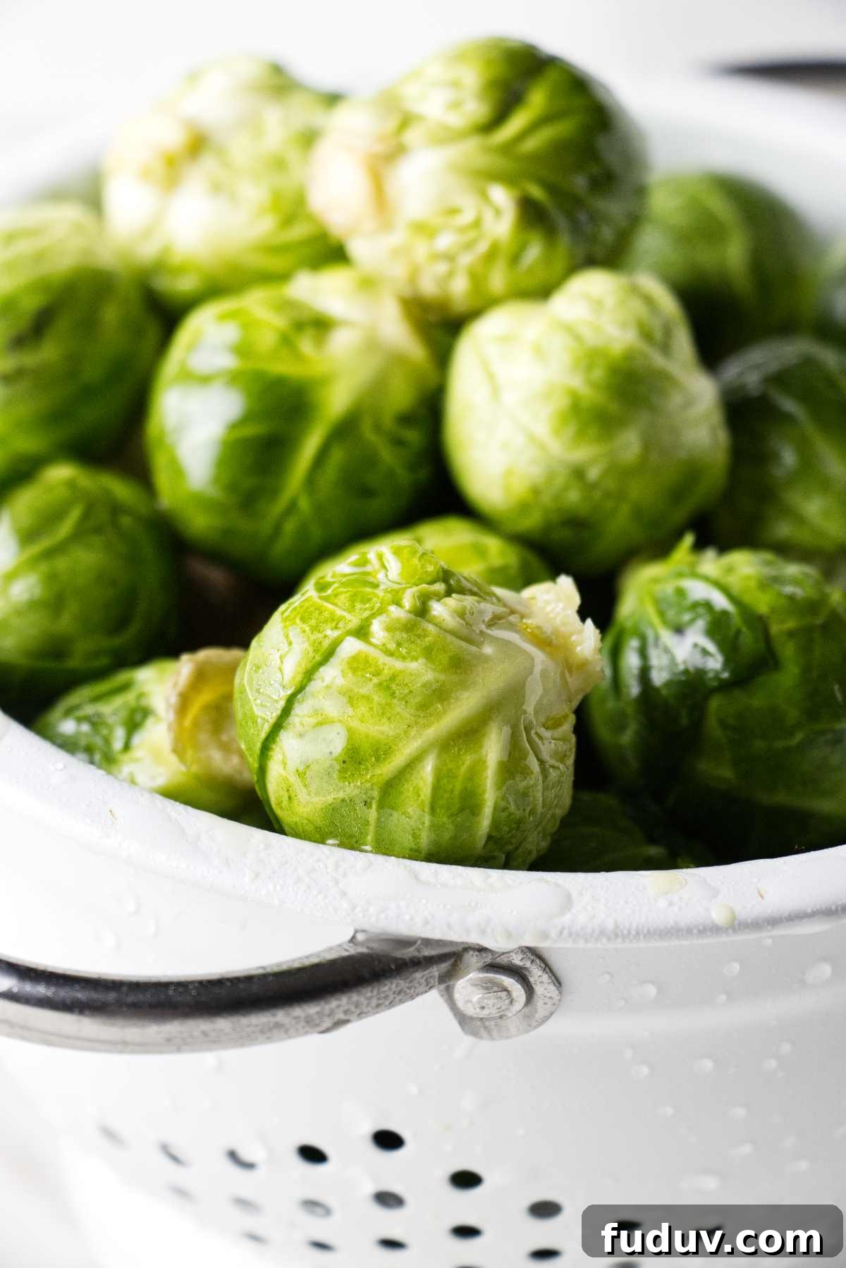 Honey Sriracha Roasted Brussels Sprouts 3 Freshly washed Brussels sprouts in a colander.