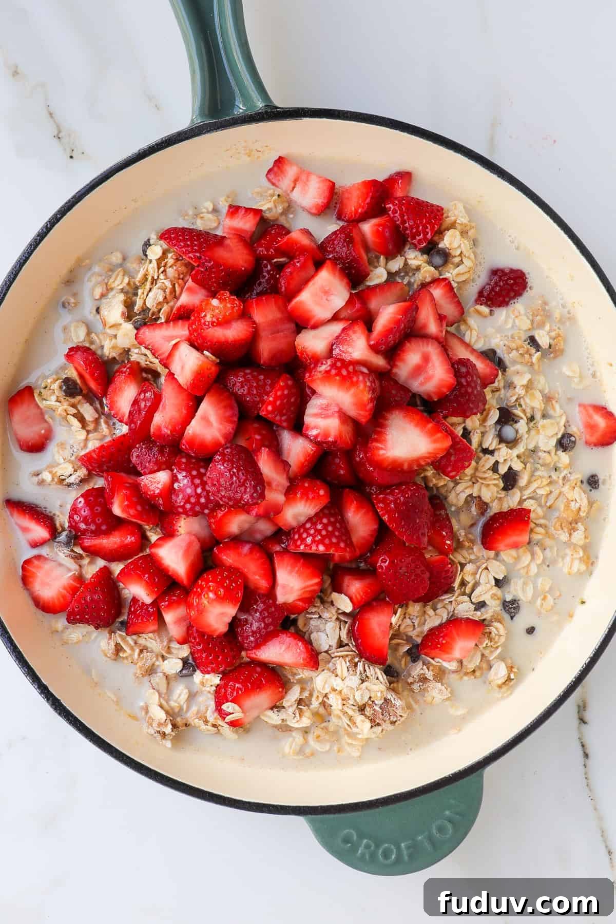 Strawberries and milk added to the pan with the dry ingredients.