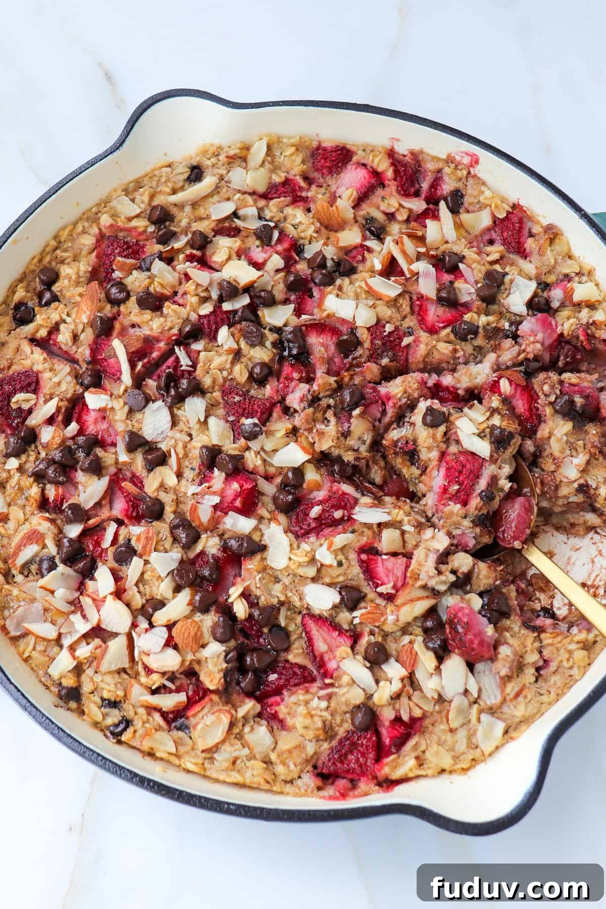 Side shot of baked oats with spoon dug in.