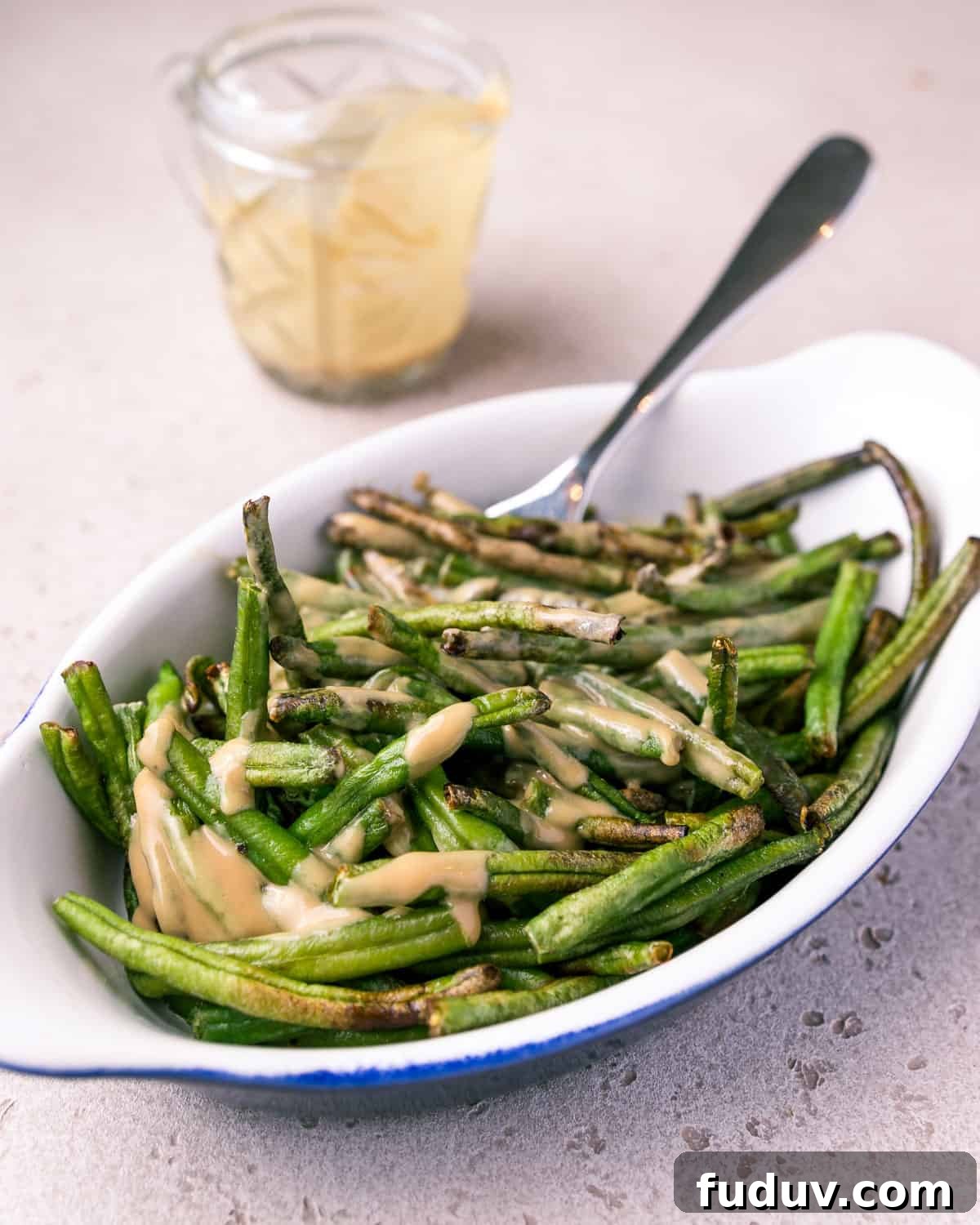 Crispy Air-Fried Frozen Green Beans with Creamy Tahini Sauce 16 Photo of a dish of air fried green beans mixed with tahini and tamari sauce.