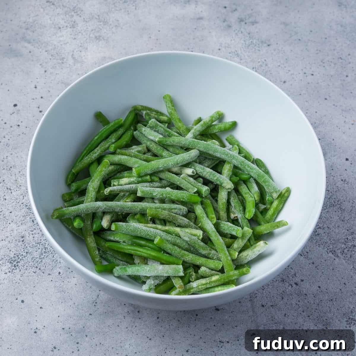 Crispy Air-Fried Frozen Green Beans with Creamy Tahini Sauce 3 Photo showing a bowl of frozen green beans.