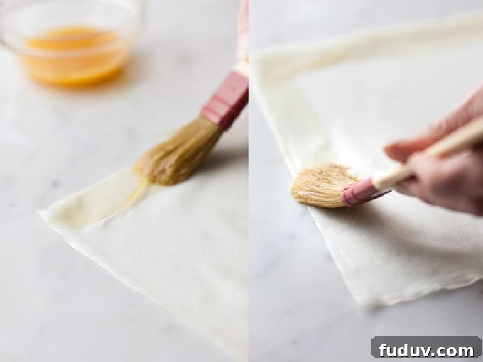 Brushing spring rolls with egg wash