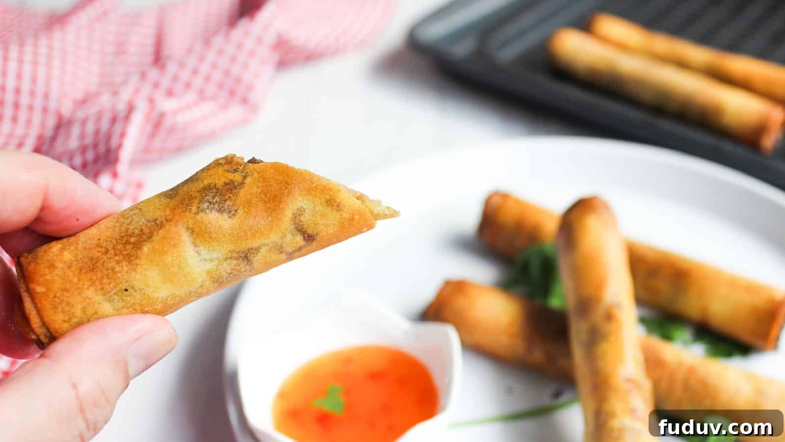 Filipino spring rolls in a basket with dipping sauce.