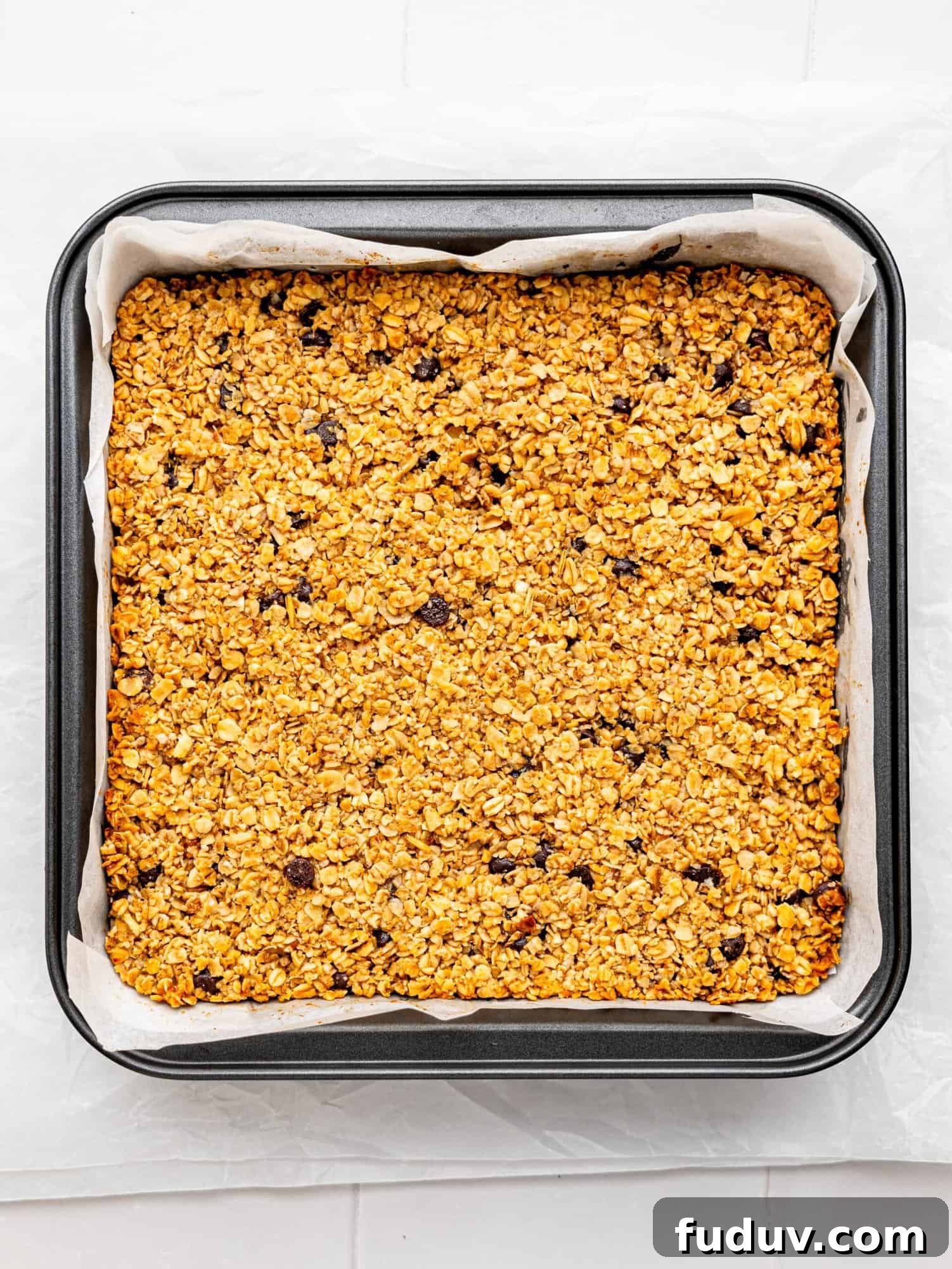 Freshly baked flapjacks in a baking tin.