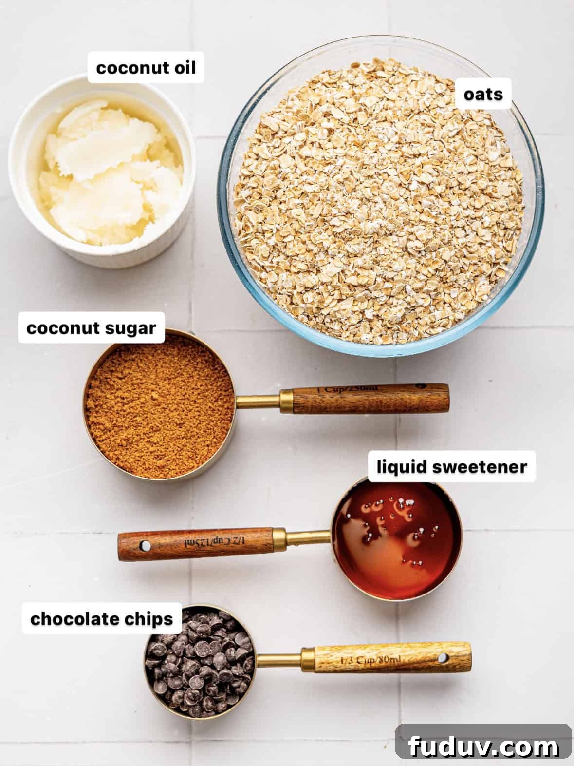 Ingredients to make chocolate chip flapjacks in measuring cups.