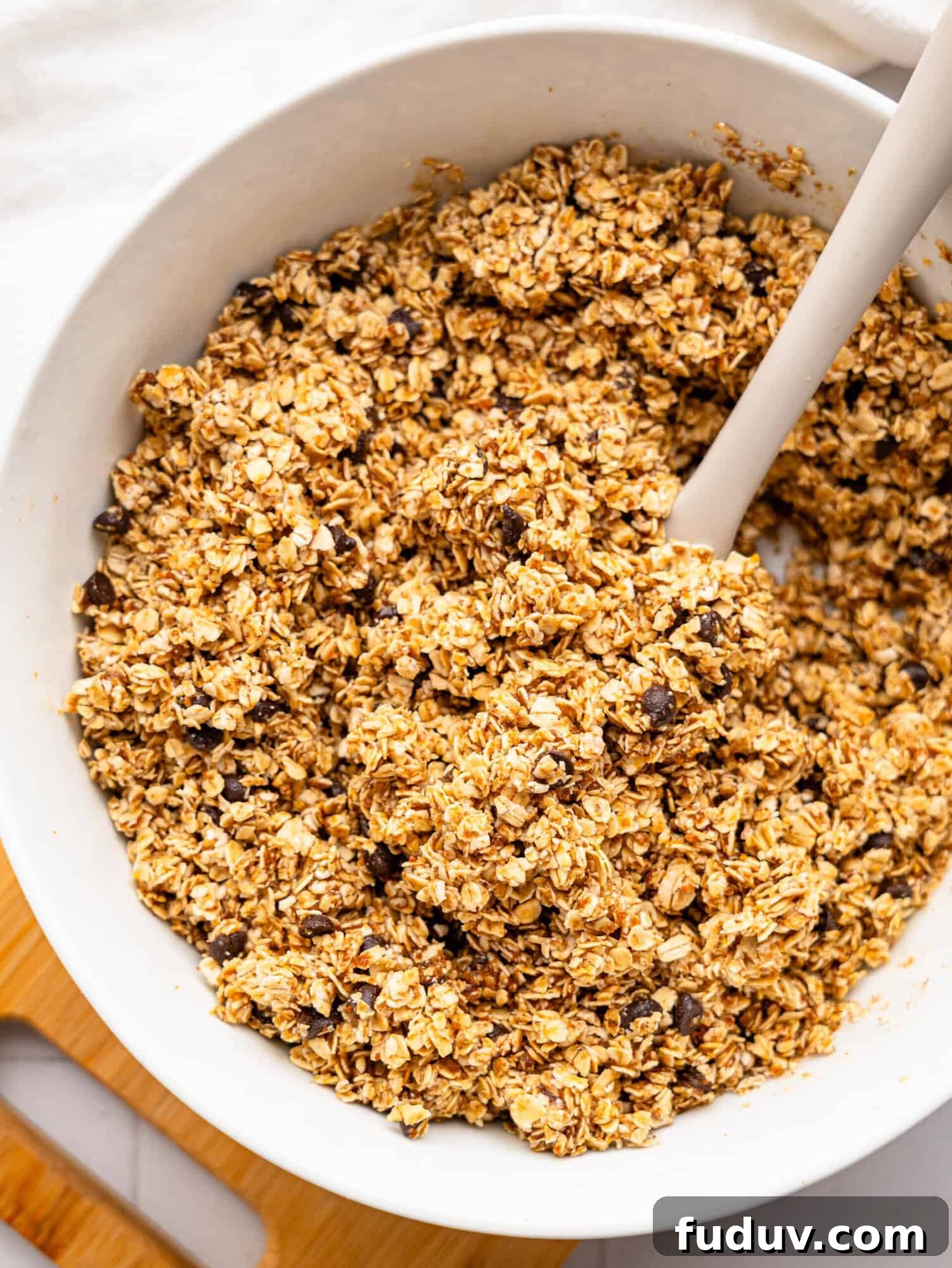 Chocolate chip flapjack mixture in a white bowl.