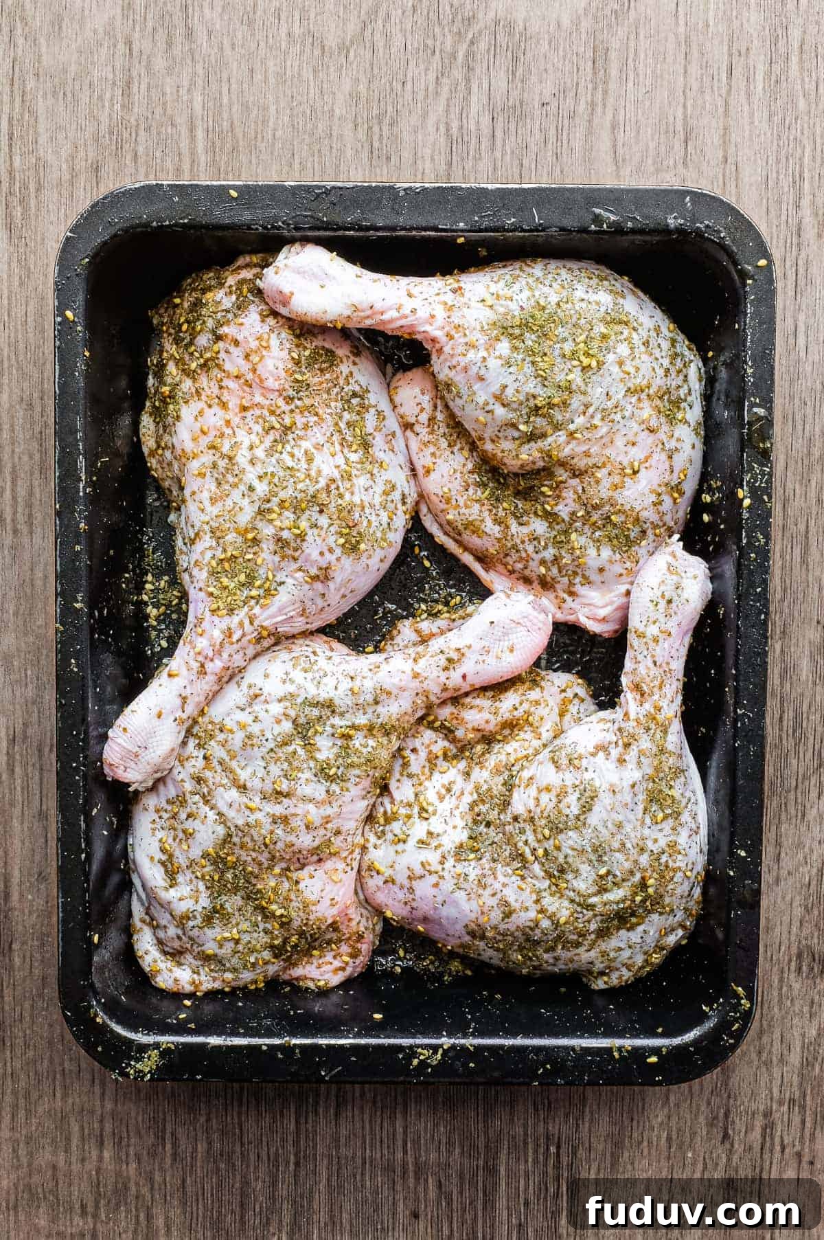4 raw duck legs, scattered with zaatar in a baking tin