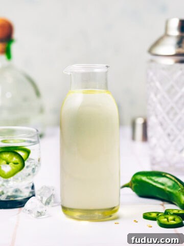 Jalapeño Simple Syrup in a glass bottle for cocktails.
