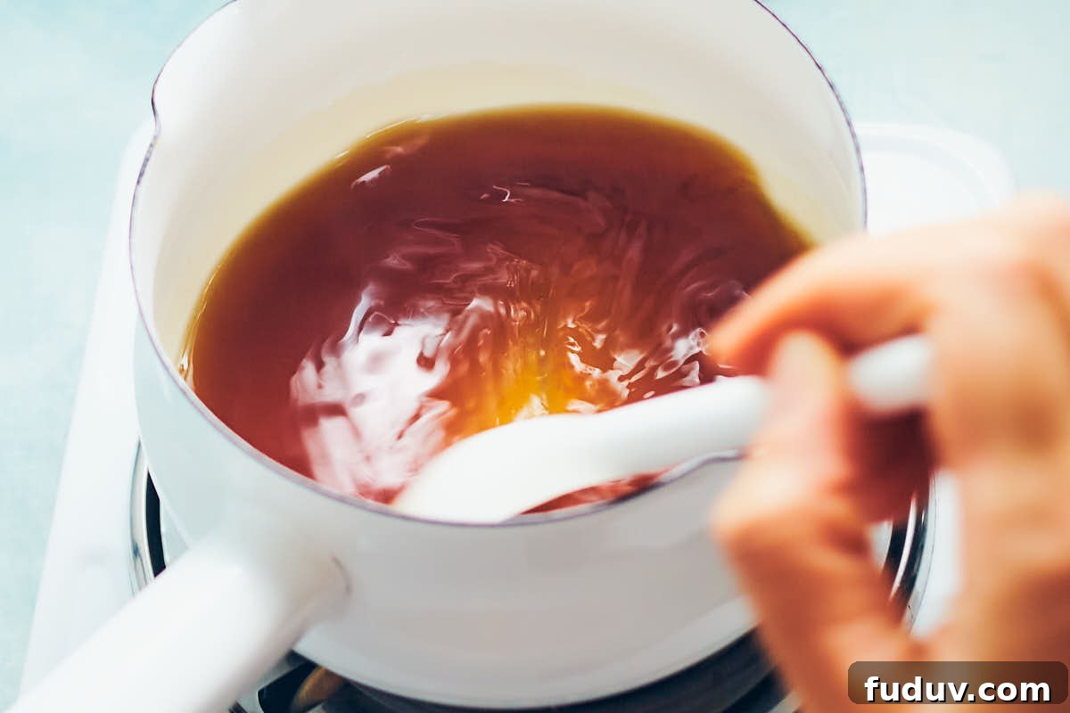 Warming brown sugar and water in a pot for syrup.