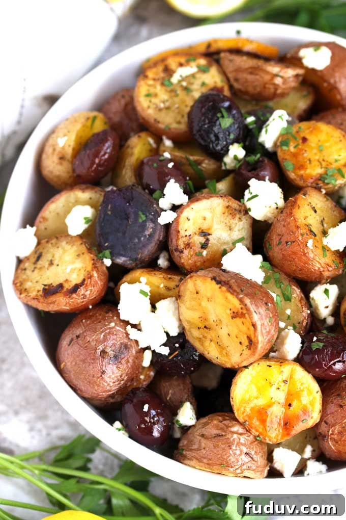 Crispy Greek-Style Roasted Potatoes with Lemon and Oregano 4 Pictured here a white bowl filled with Roasted Greek Potatoes.