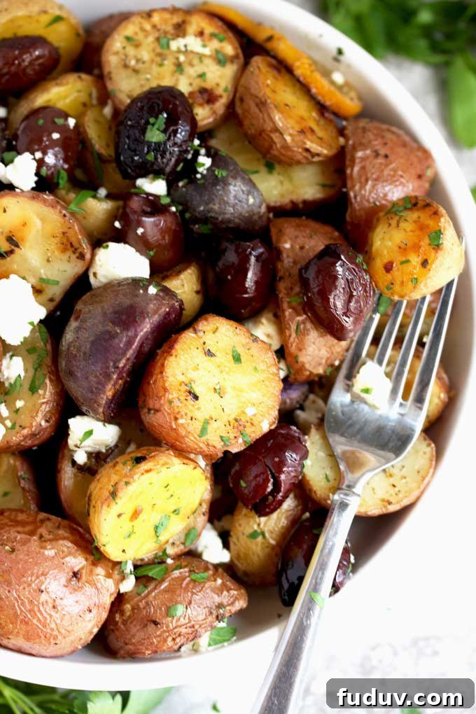 Crispy Greek-Style Roasted Potatoes with Lemon and Oregano 8 Greek Potatoes in a white serving bowl