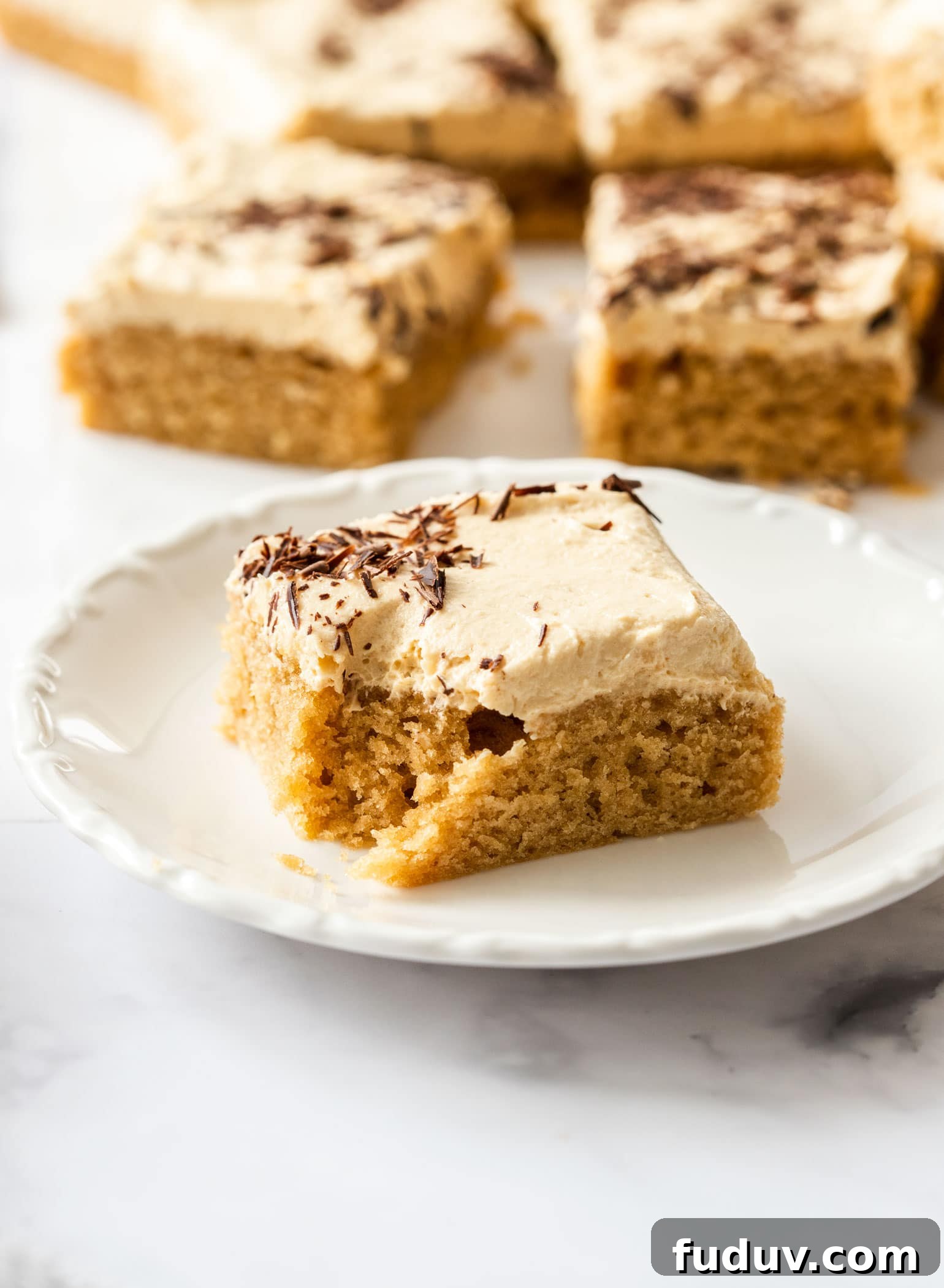 Ultimate Peanut Butter Sheet Cake Recipe for Gatherings 7 a slice of peanut butter sheet cake on a white saucer