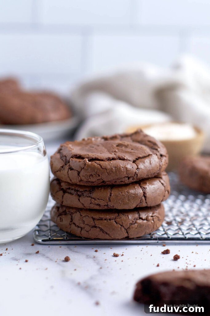 Chewy Brownie Crinkle Cookies Recipe for Fudgy Chocolate Lovers 5 stack of three cookies with a glass of milk