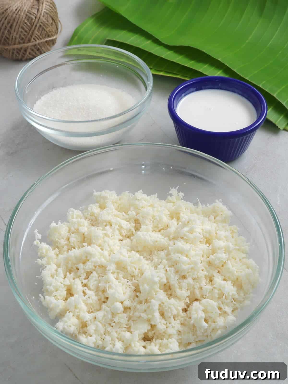 grated cassava, sugar, coconut milk, banana leaves