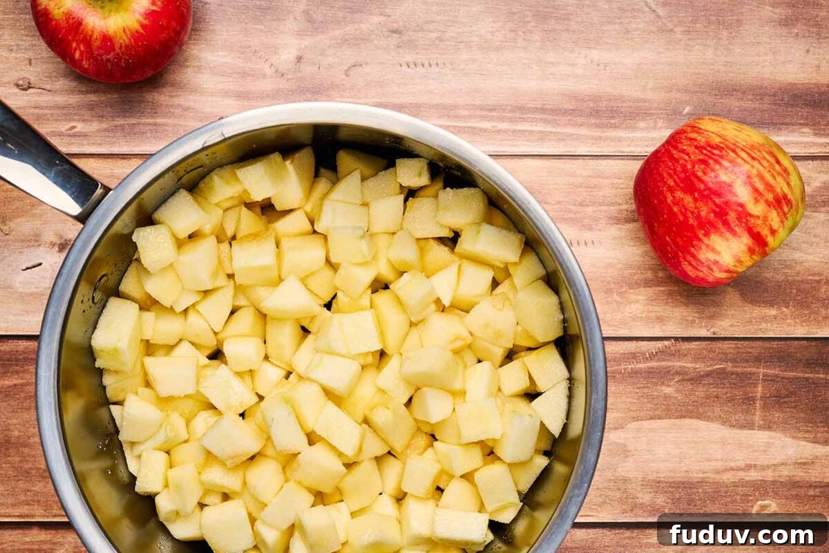 Homemade Cinnamon Applesauce Recipe: Warm Spice & Comfort 4 A photo of chopped apples in a saucepan, demonstrating the proper size of the apple chunks for making homemade applesauce.