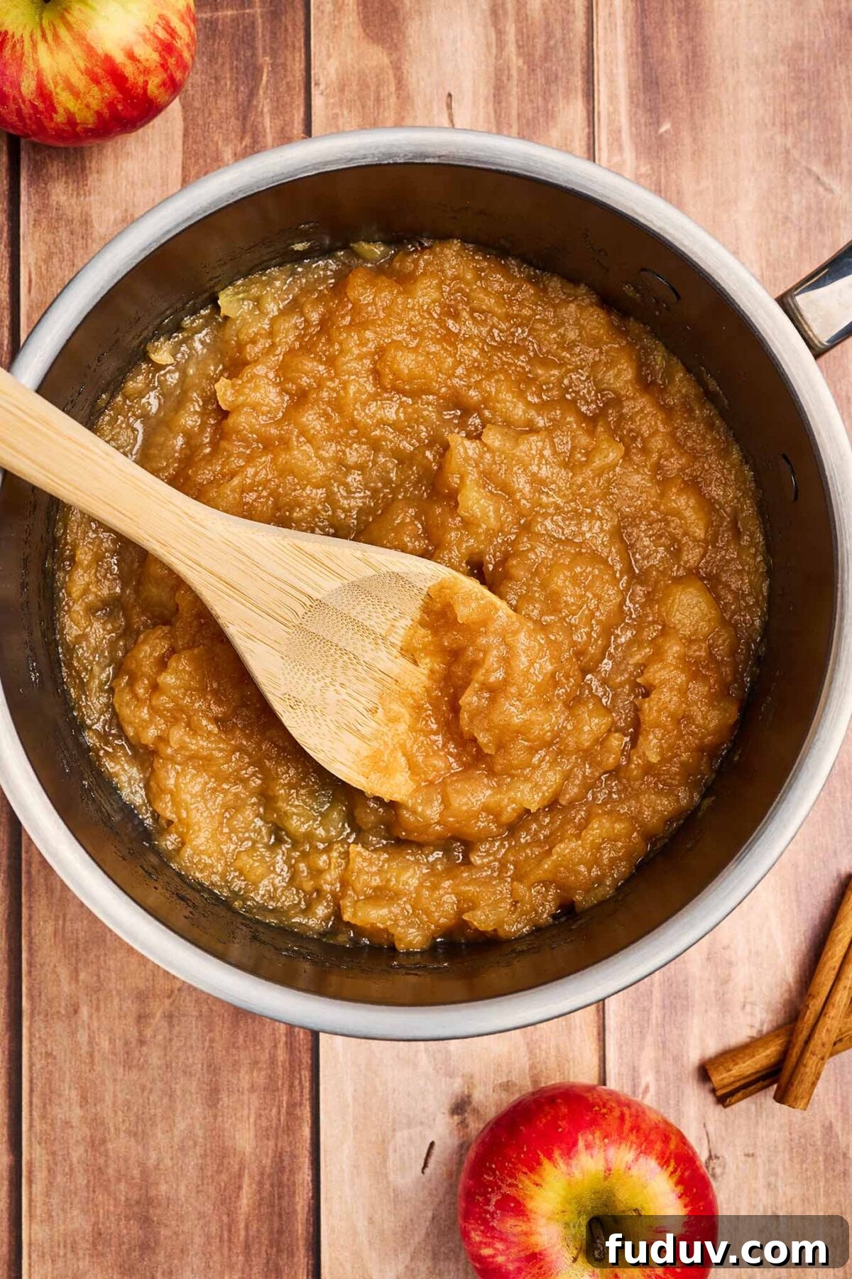 Homemade Cinnamon Applesauce Recipe: Warm Spice & Comfort 6 A saucepan filled with apples, lemon juice, spices, and vanilla that have cooked down to the proper consistency for applesauce.
