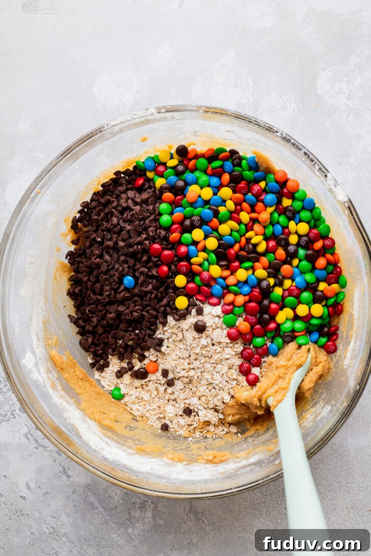 Cookie dough with fillings in a bowl.