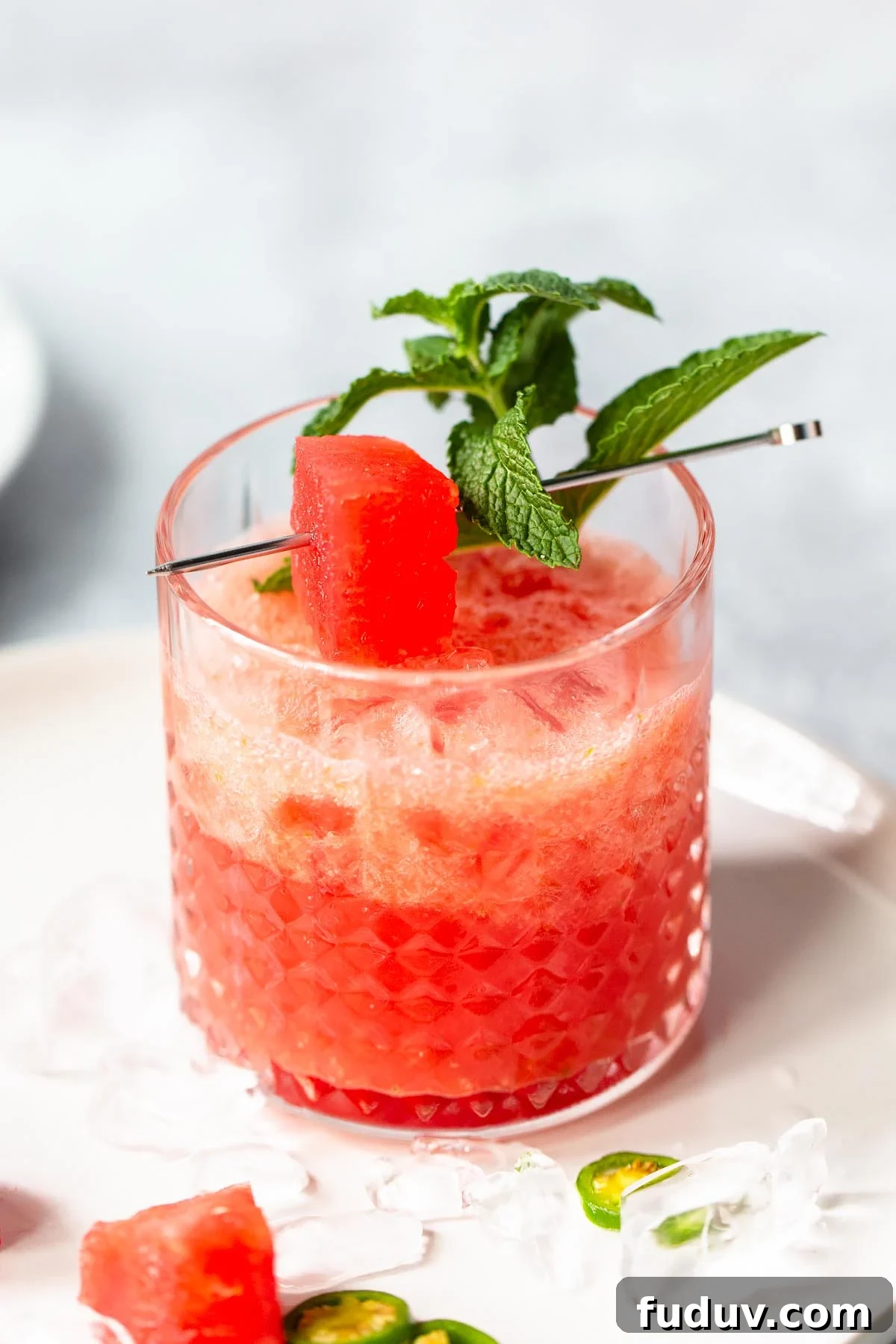 watermelon mocktail up close with a watermelon and mint garnish