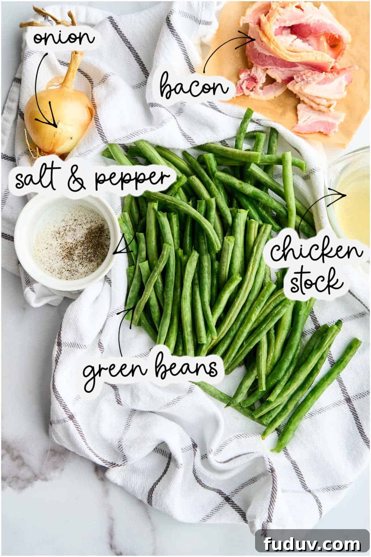 green beans, bacon, onion, chicken stock, and salt and pepper on marble counter