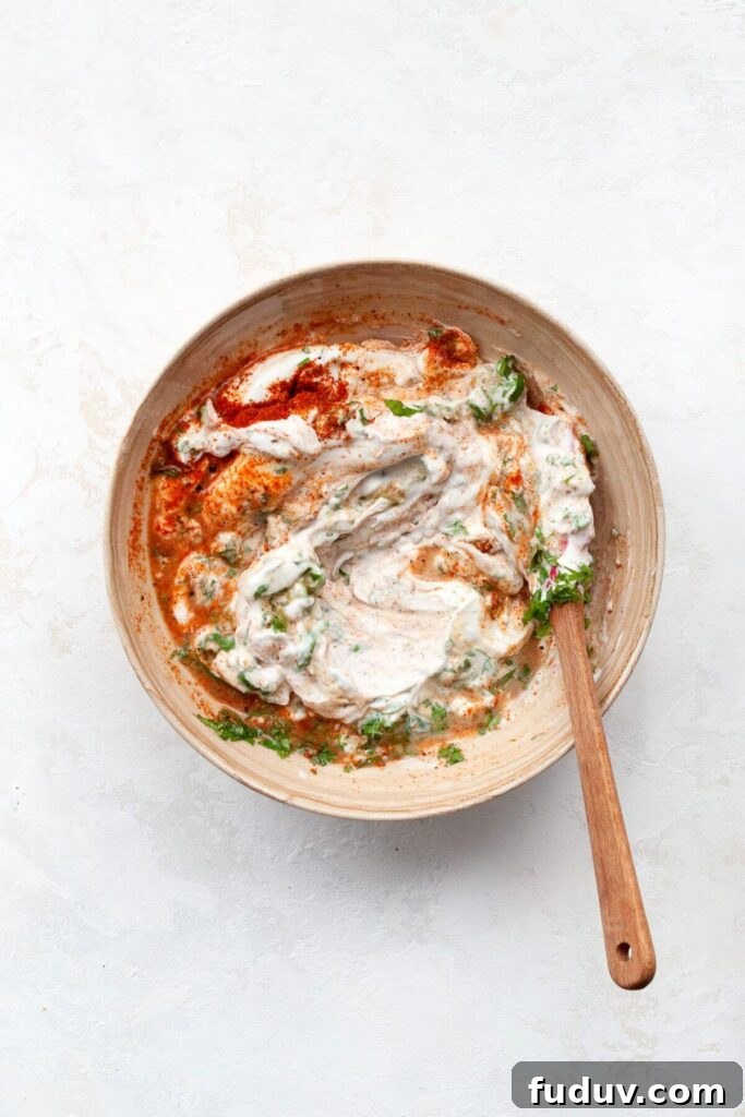 cilantro lime cream made from greek yogurt in a mixing bowl