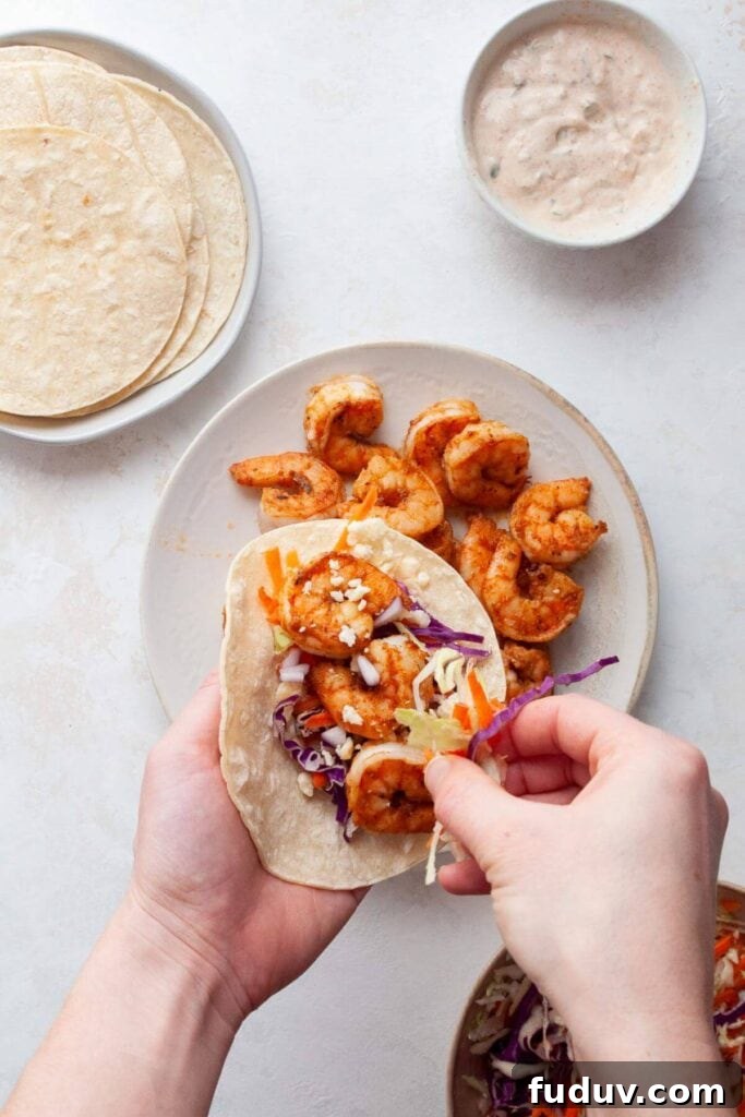 assembling healthy shrimp tacos on corn tortillas