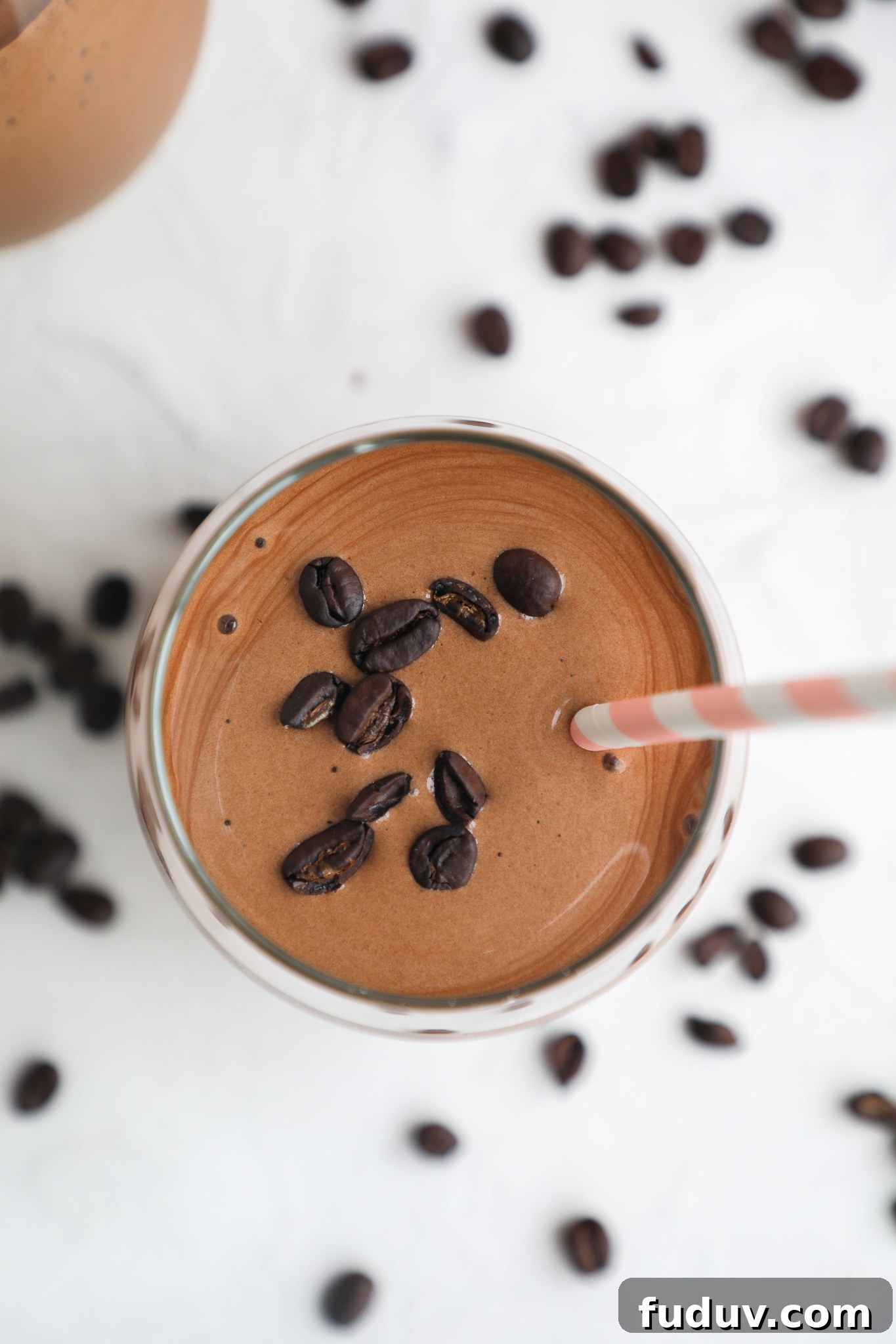 Creamy Mocha Protein Smoothie Recipe for Energy and Muscle Recovery 6 A top view of a coffee smoothie topped with coffee beans