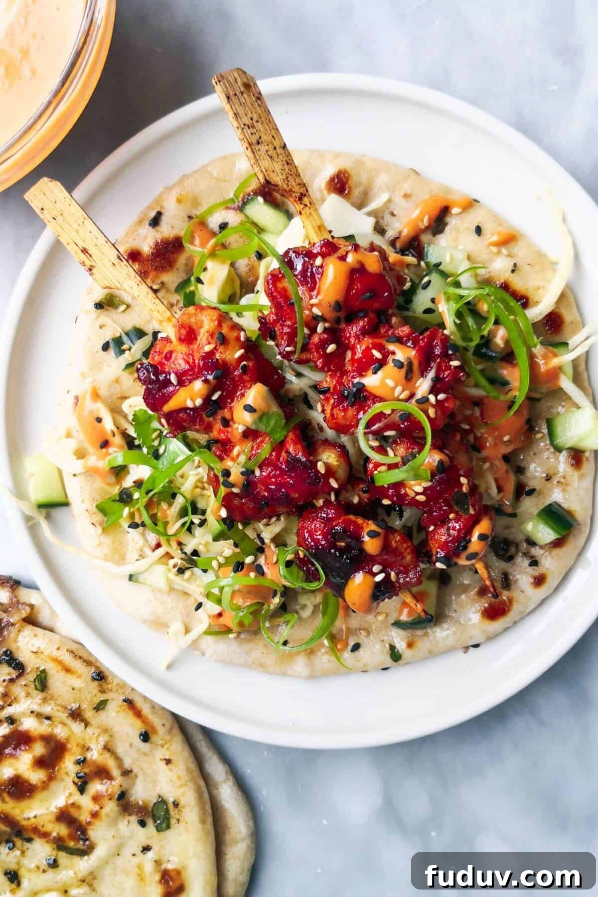 Sticky Gochujang Chicken Recipe: Sweet Spicy Korean Glaze 2 Two gochujang chicken skewers on slaw and flatbread