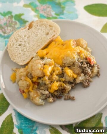 Serving crock pot Tater Tot Casserole with sliced Italian bread.